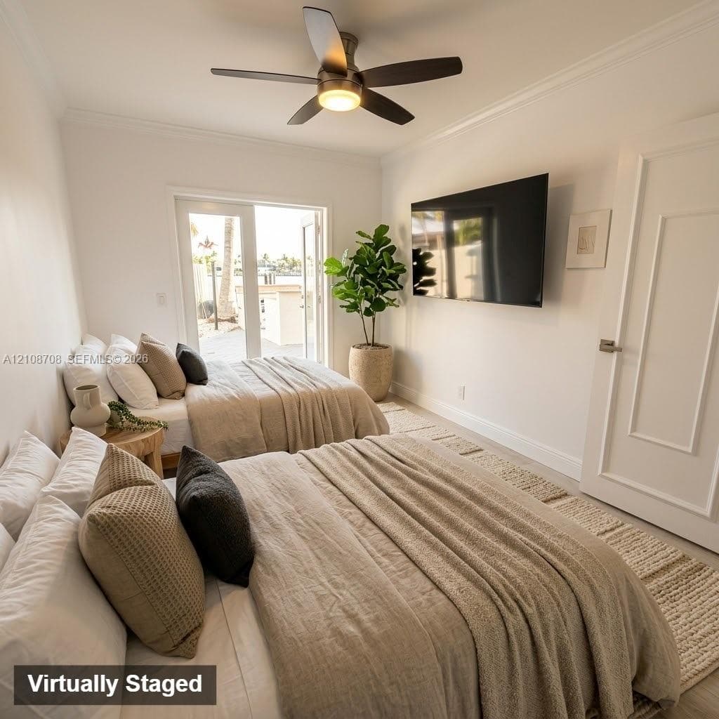 Neutral walls featuring crown molding, five-blade ceiling fan with integrated lighting, solid-core interior door with brushed metal hardware, and full-glass panel French doors