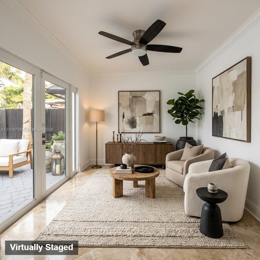Polished stone flooring, crown molding, multi-panel glass door system, and a five-blade ceiling fan with integrated lighting