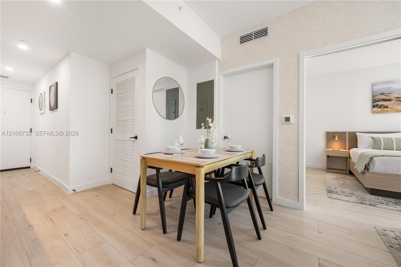 Wood-finish flooring, recessed lighting, and louvered-style closet doors