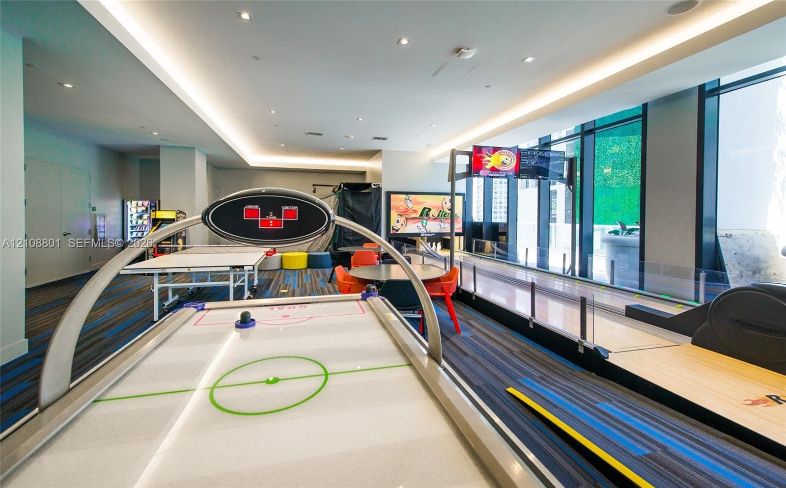 Recreation area featuring floor-to-ceiling windows, recessed lighting, and patterned wall-to-wall carpeting
