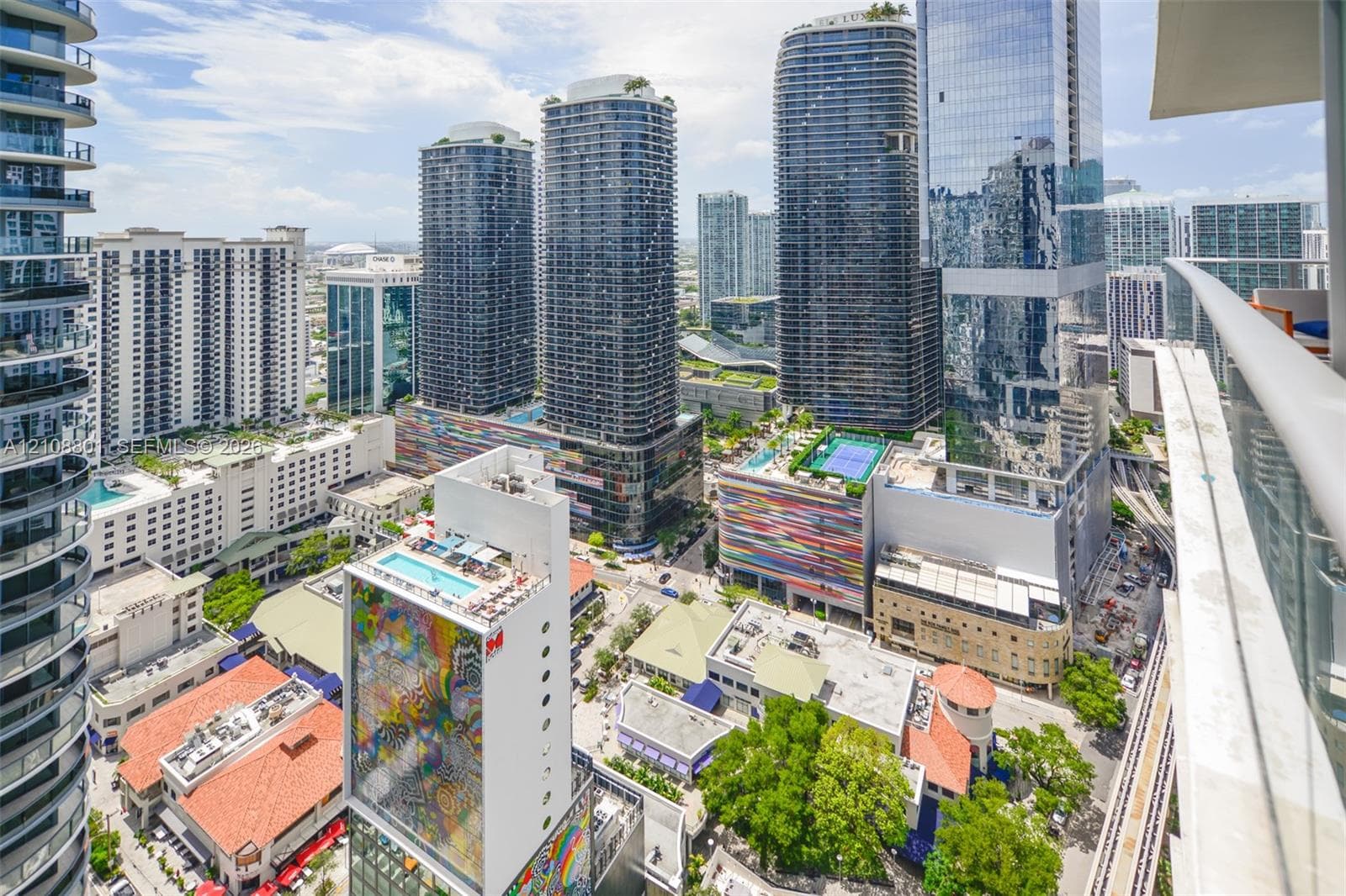 Private balcony featuring a metal railing with expansive urban architecture and cityscape scenery