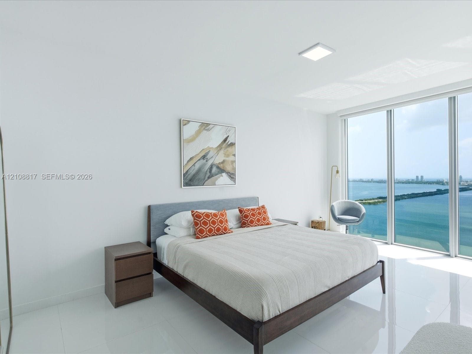 Floor-to-ceiling windows, polished tile flooring, and recessed ceiling lighting