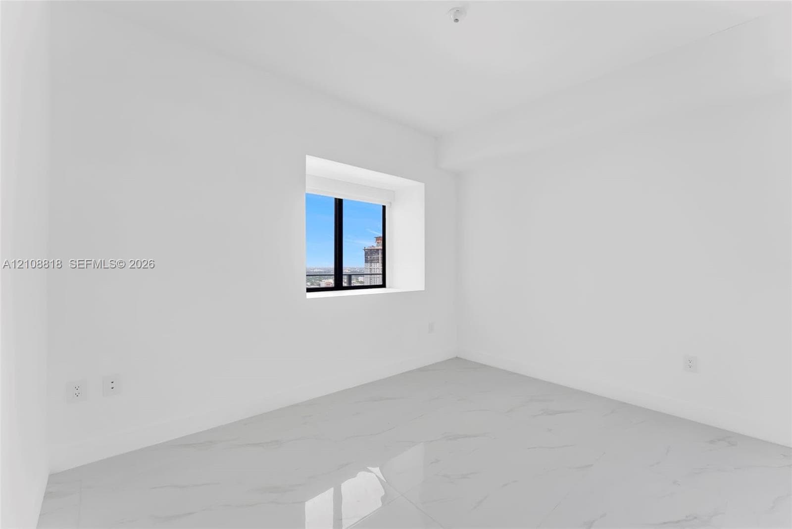 Minimalist room featuring high-gloss, veined stone-finish tile flooring, crisp white walls, and a recessed window with black framing