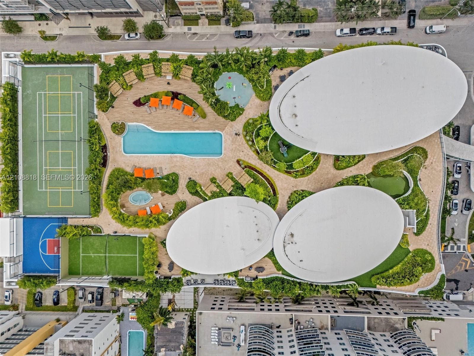 Recreational deck featuring a swimming pool, tennis court, basketball court, and curated landscaping with paved pathways