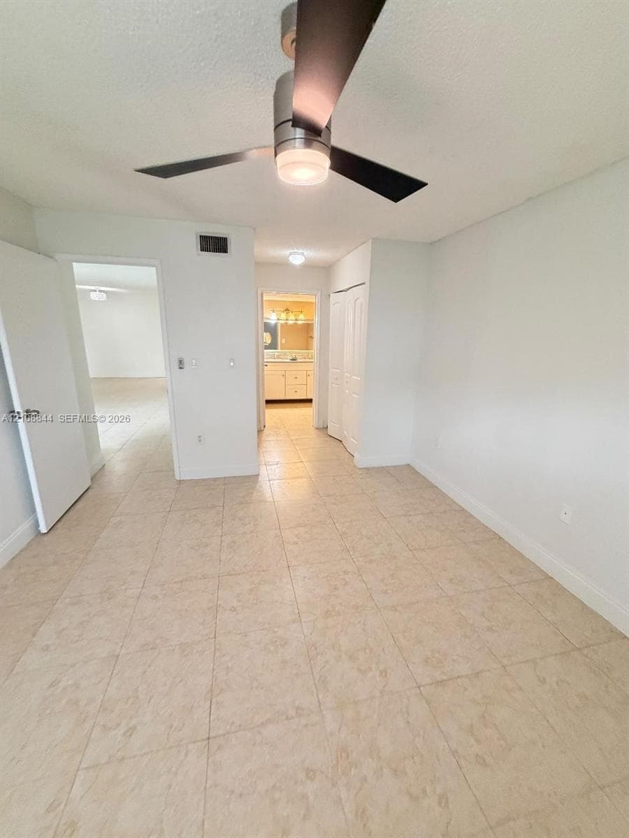 Tile flooring, ceiling fan with integrated light fixture, and closet with bi-fold doors