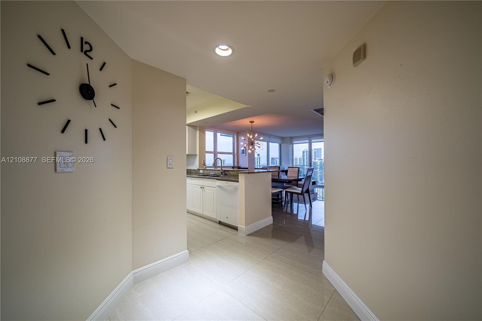 Ceramic tile flooring, recessed lighting, white cabinetry, and stone-surface countertops