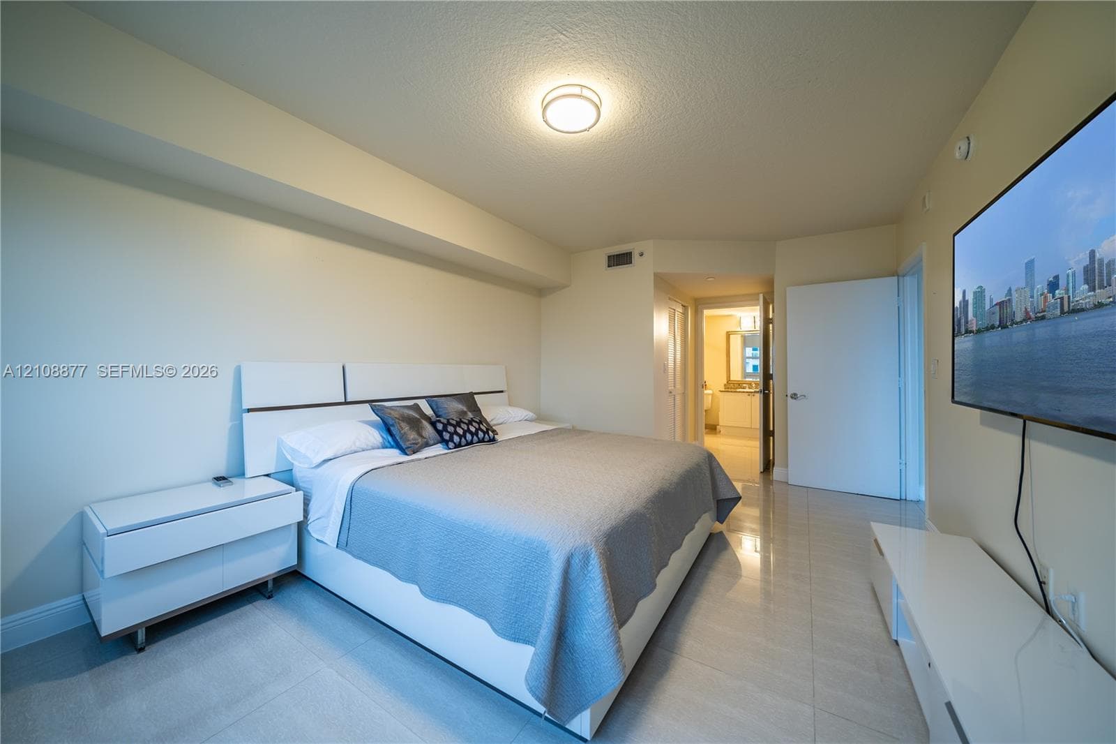 Neutral-toned interior featuring polished tile flooring, recessed lighting, and a smooth ceiling finish