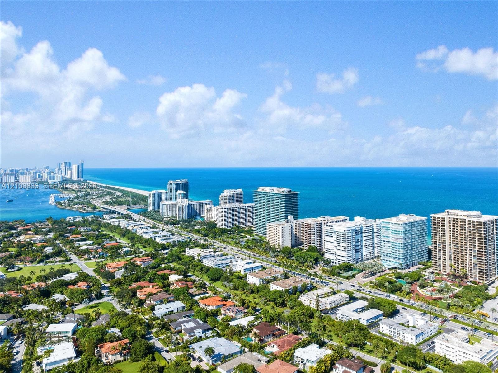 Aerial perspective of coastal landscape featuring high-rise architecture, extensive shoreline, Atlantic Ocean horizon, and tropical vegetation