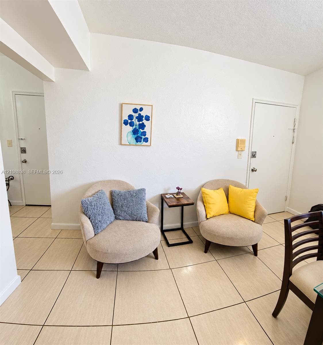 Large-format neutral floor tiling throughout and dual interior doors with metal hardware