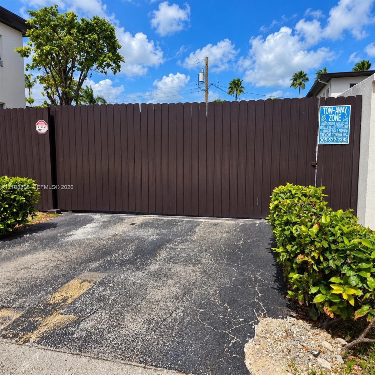 Solid wood-finish privacy gate with scalloped top detailing