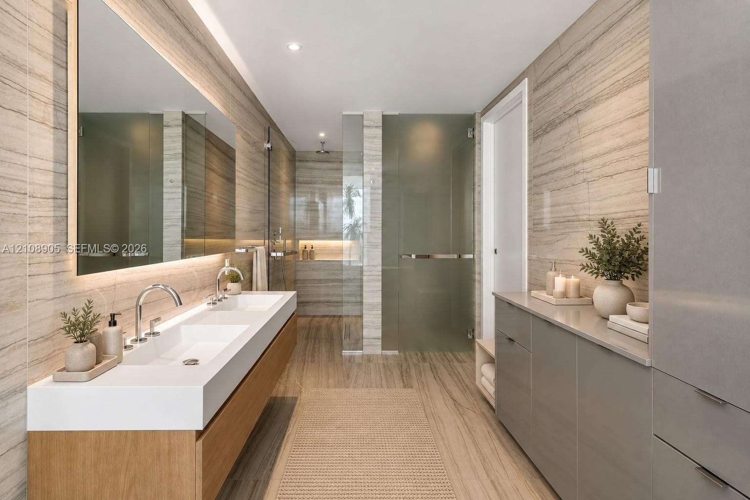 Floating wood-finish double vanity with an integrated countertop, large-format linear wall tile, oversized rectangular mirror with integrated lighting, glass-enclosed shower, and sleek built-in cabinetry