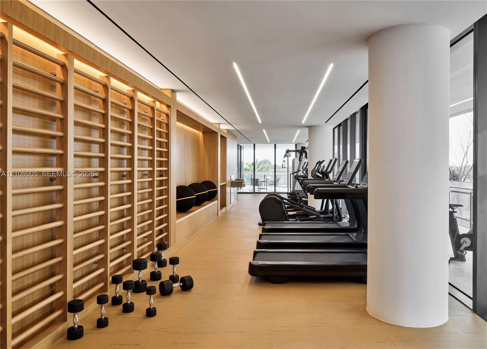 Custom light-wood built-in wall ladder system, integrated linear LED recessed lighting, expansive floor-to-ceiling windows, and wood-finish flooring