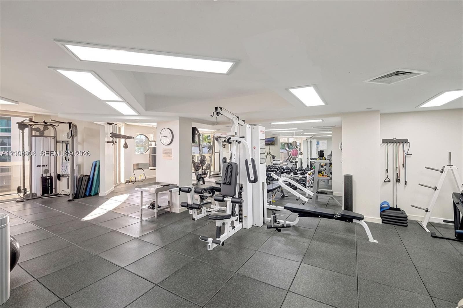 Fitness facility featuring rubberized flooring and recessed rectangular lighting panels