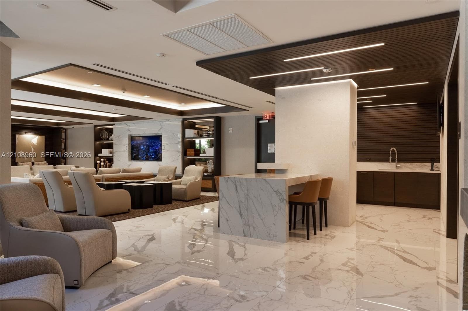 Polished stone tile flooring, central stone-surfaced island, recessed linear ceiling lighting, dark wood-finish slat detailing, and built-in display cabinetry