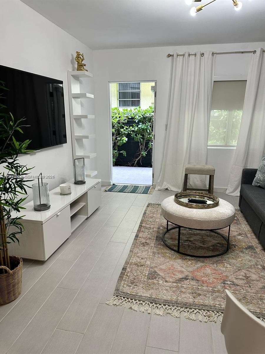 Neutral-toned tile flooring, built-in floor-to-ceiling shelving, recessed ceiling lighting, and a multi-pane window
