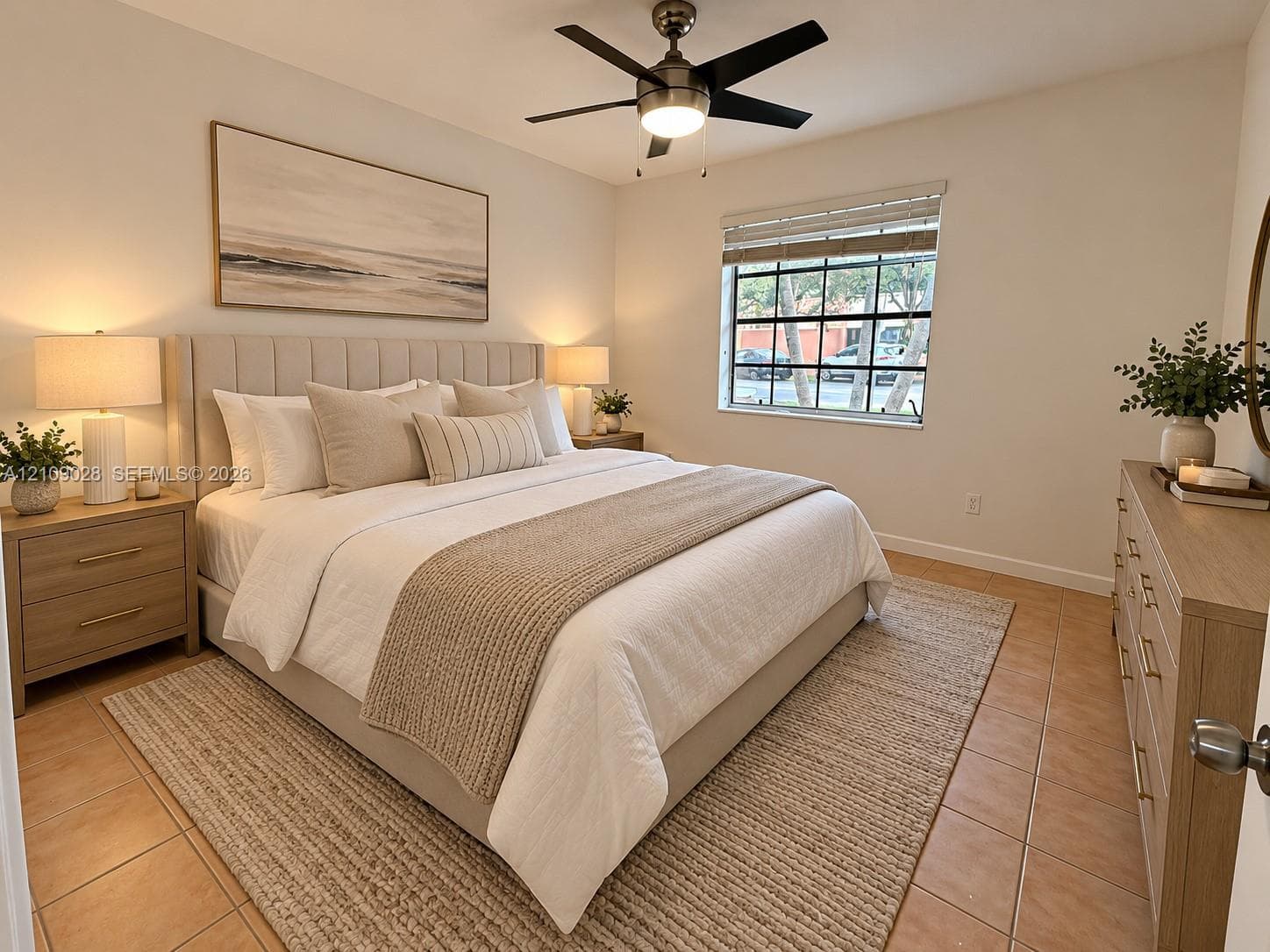 Neutral interior space featuring tile flooring, a multi-pane window with blinds, and a brushed nickel ceiling fan with integrated lighting