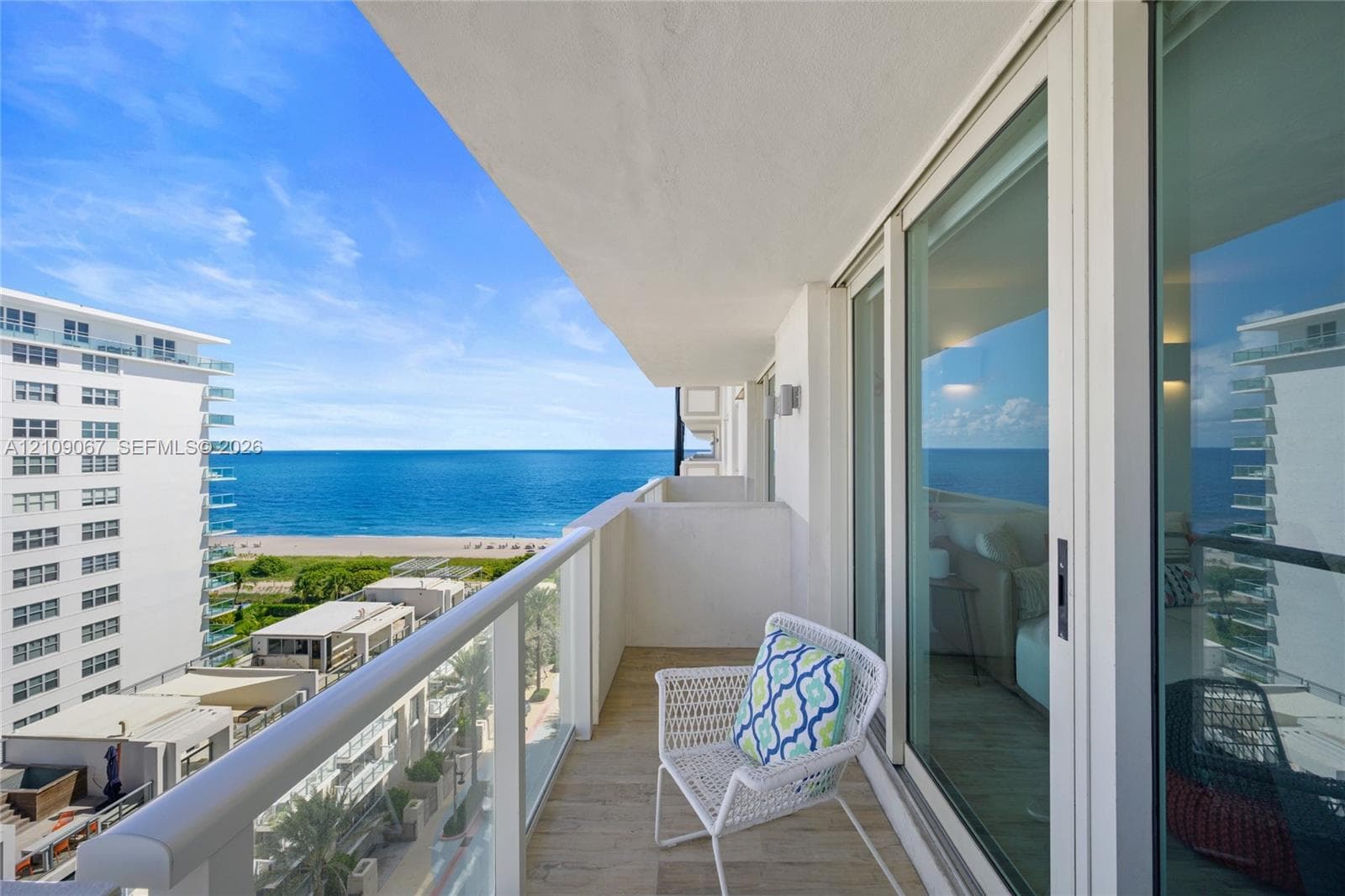 Private balcony featuring tile flooring, a glass-panel railing, and floor-to-ceiling sliding glass doors