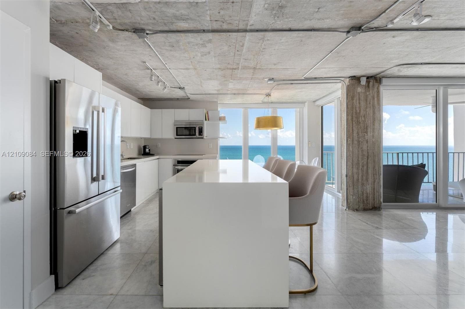 Direct oceanfront access featuring a sandy shoreline and expansive water horizon