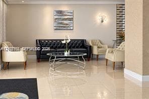 Polished large-format tile flooring, textured wall finishes, and decorative wall-mounted lighting fixtures