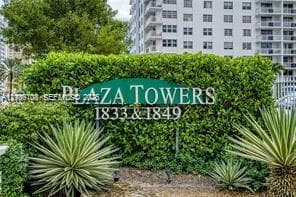 Plaza Towers signage featuring manicured hedge landscaping and architectural agave plantings