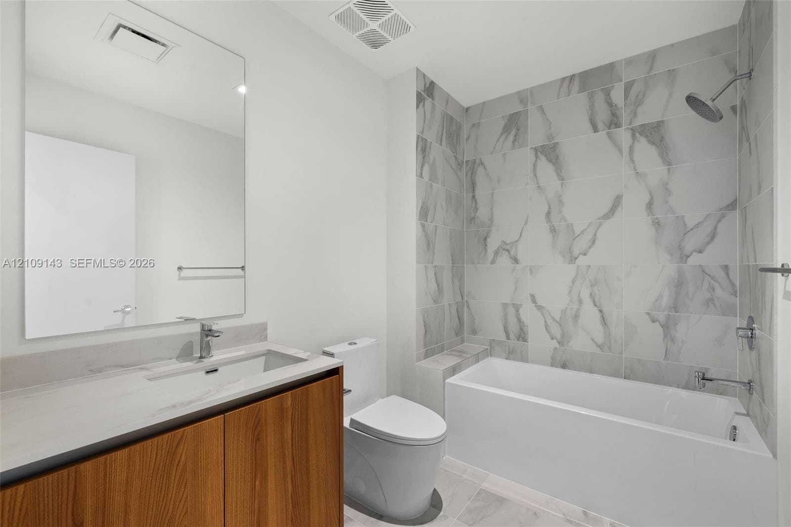 Secondary bathroom features a combination shower / tub