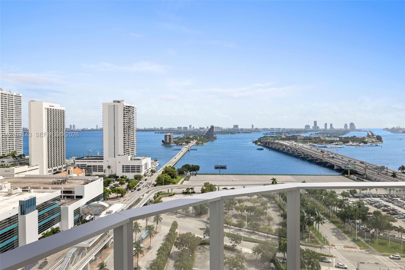 Elevated balcony featuring a glass railing with a panoramic outlook of the surrounding bay, bridges, and metropolitan skyline