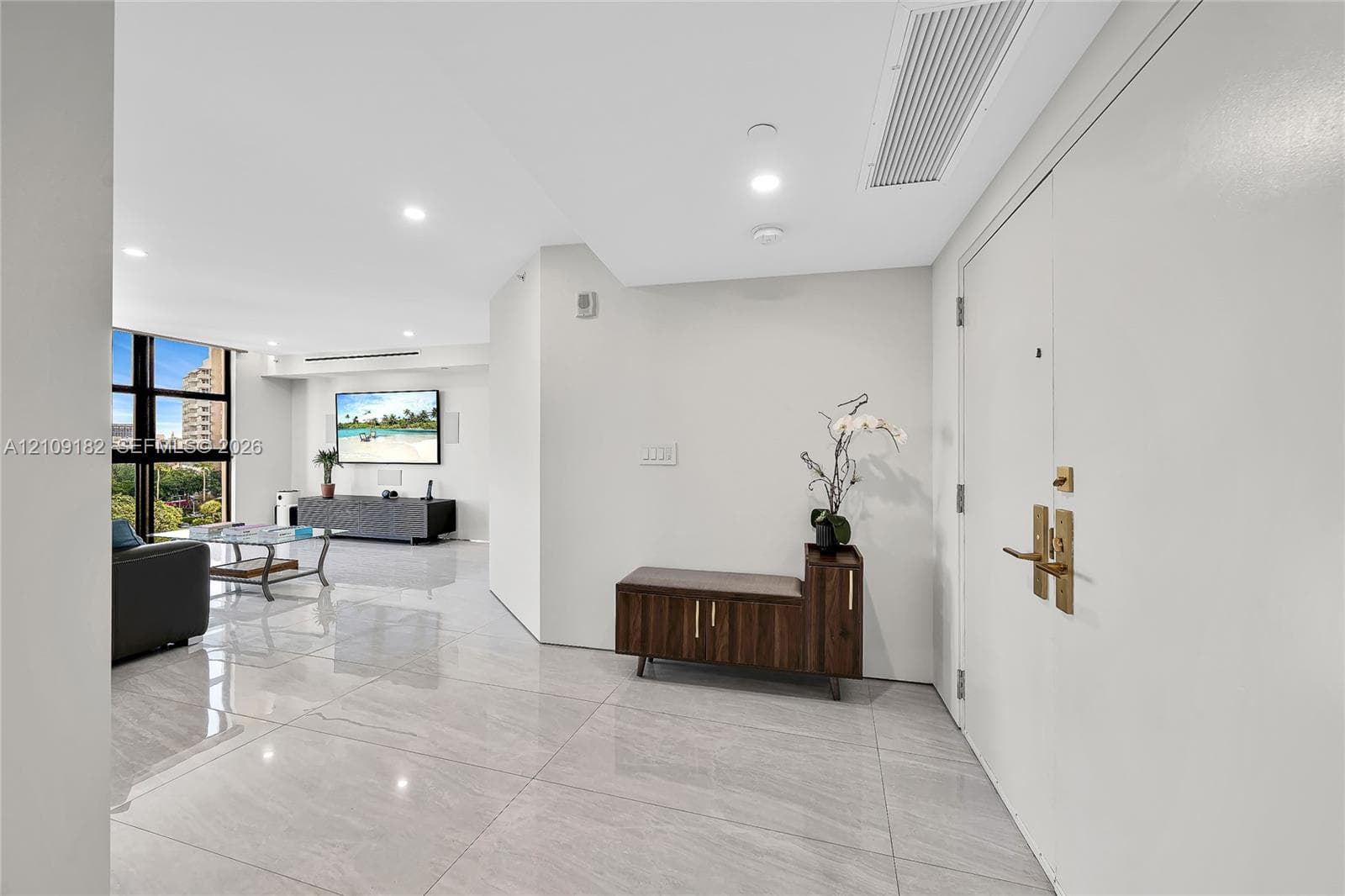 Interior space featuring light-toned tile flooring, smooth ceiling surfaces, recessed lighting, and expansive windows