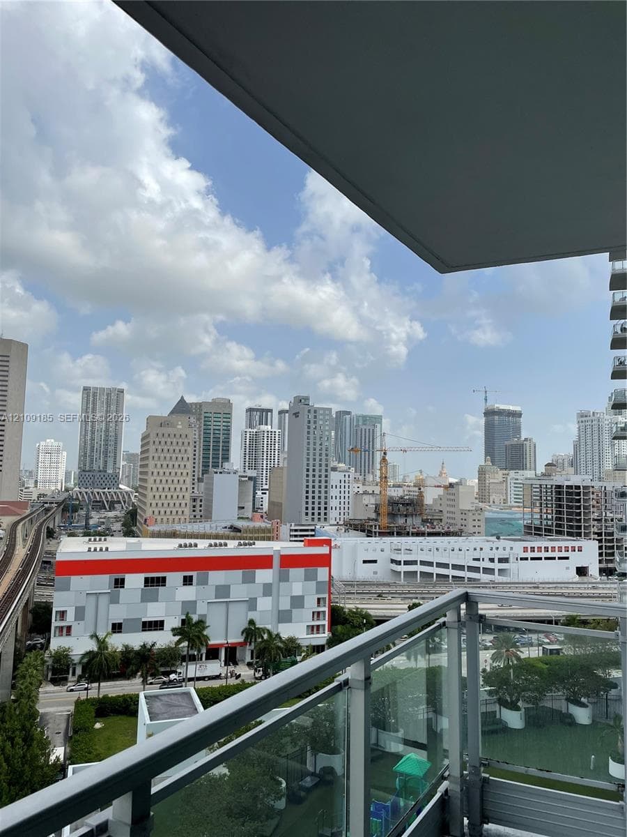 Covered balcony featuring glass railing panels