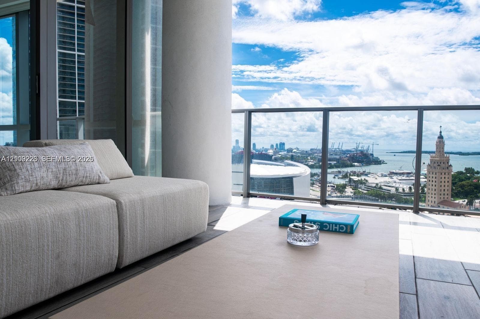 Private balcony featuring tile flooring and a glass-paneled railing