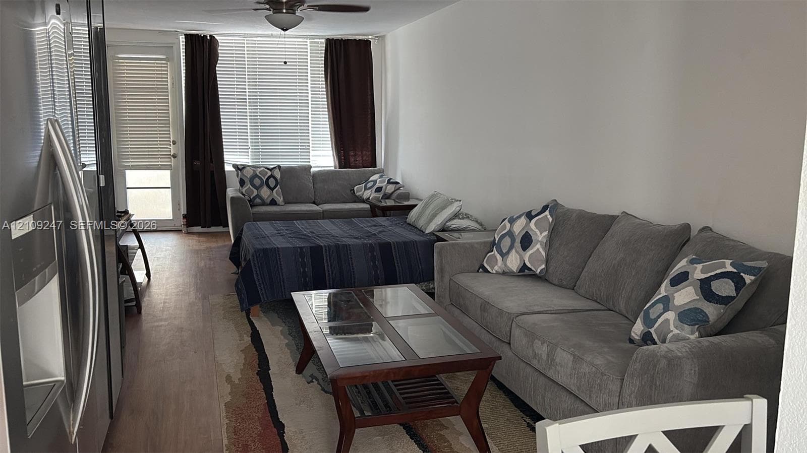 Wood-finish flooring, ceiling fan, and access to exterior door with glass insert