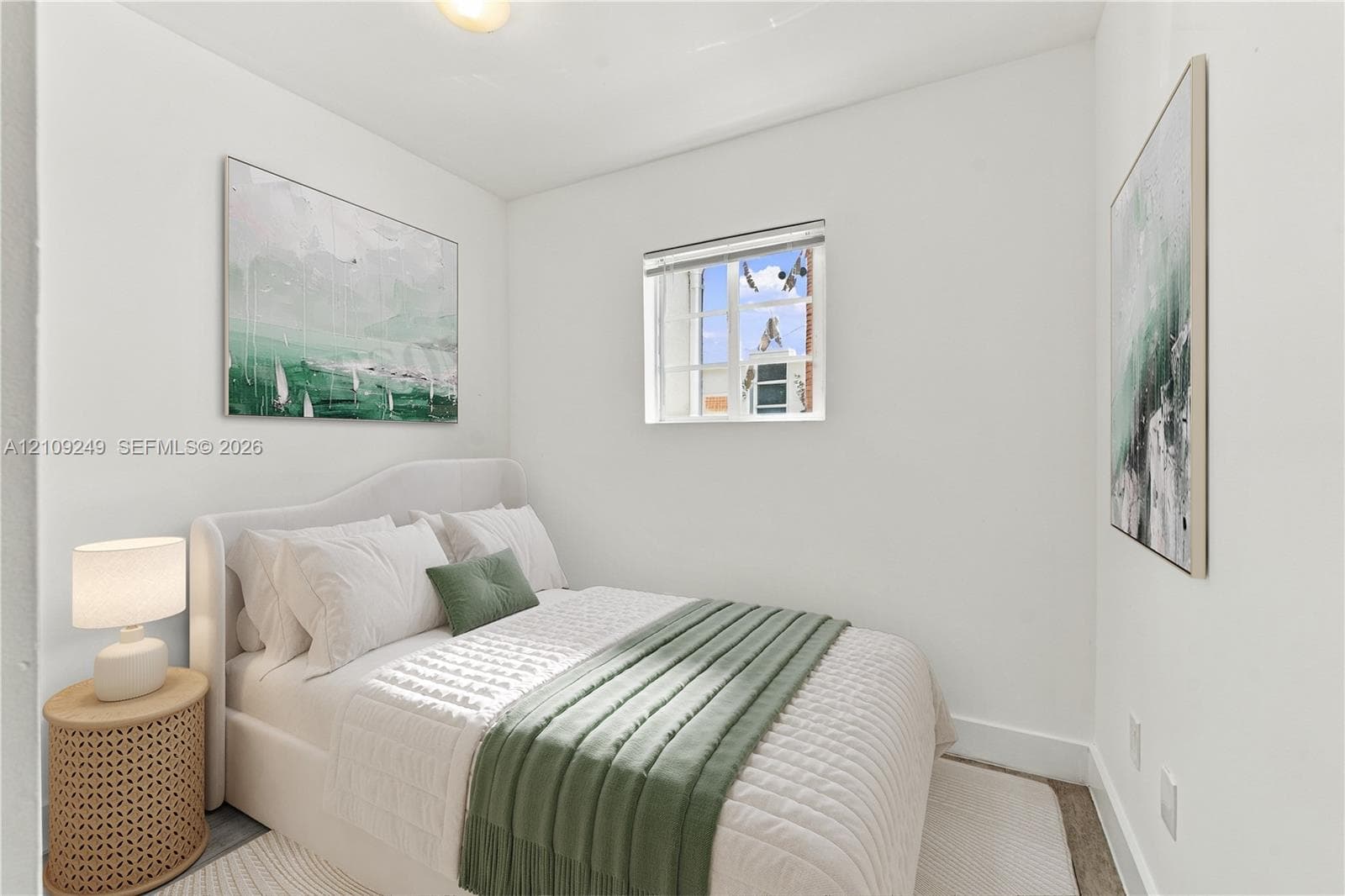 Neutral interior featuring white walls, a single-pane multi-light window, and a flush-mount ceiling fixture