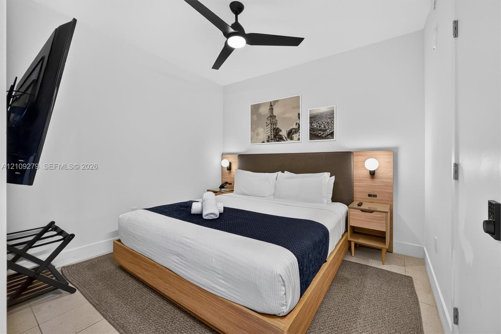 Integrated headboard with built-in wooden nightstands, matte black three-blade ceiling fan, and wall-mounted spherical light fixtures