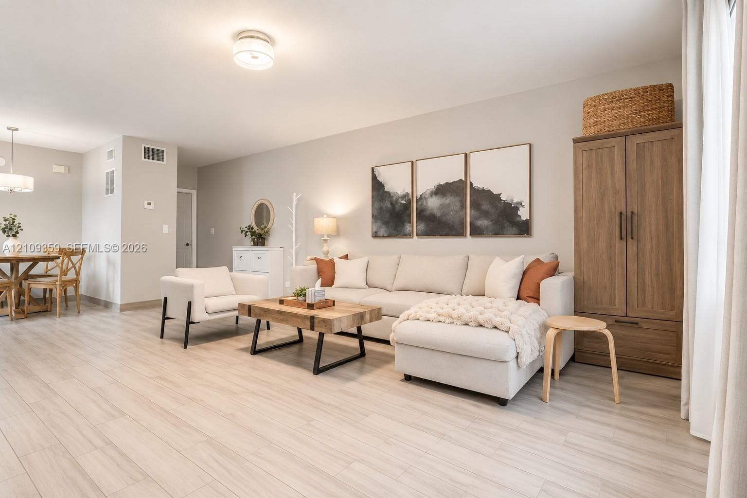 Open floor plan featuring wood-finish flooring, neutral wall color, and flush-mount ceiling lighting