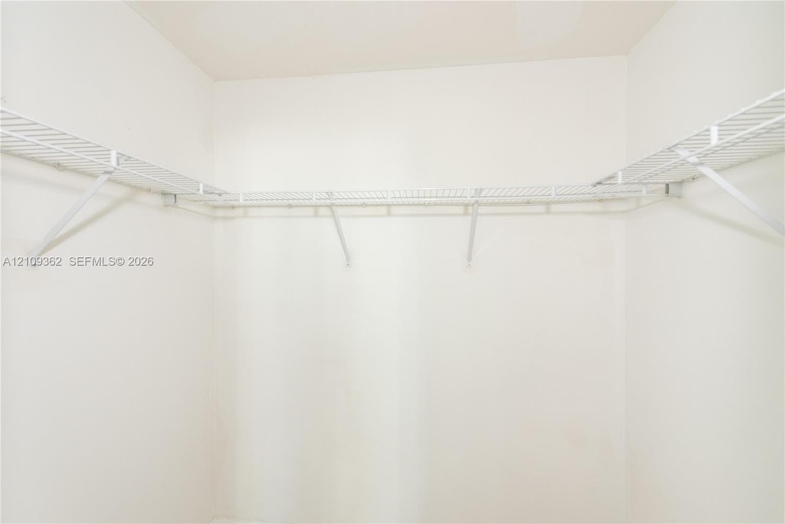 Walk-in closet featuring white wire shelving