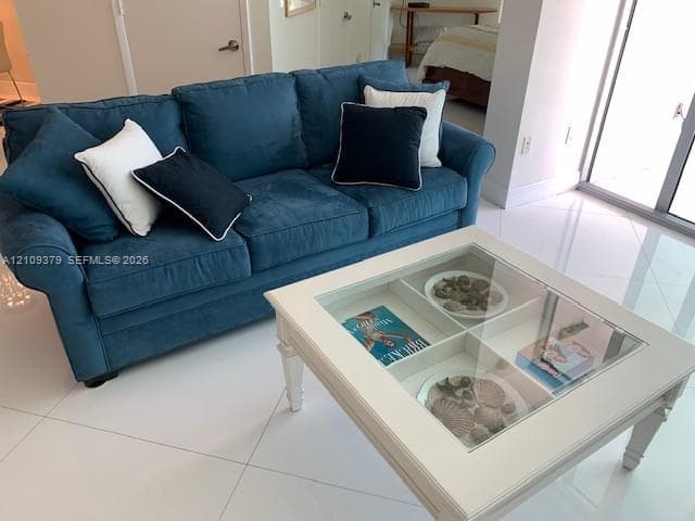 Large-format tile flooring and sliding glass door with metallic frame