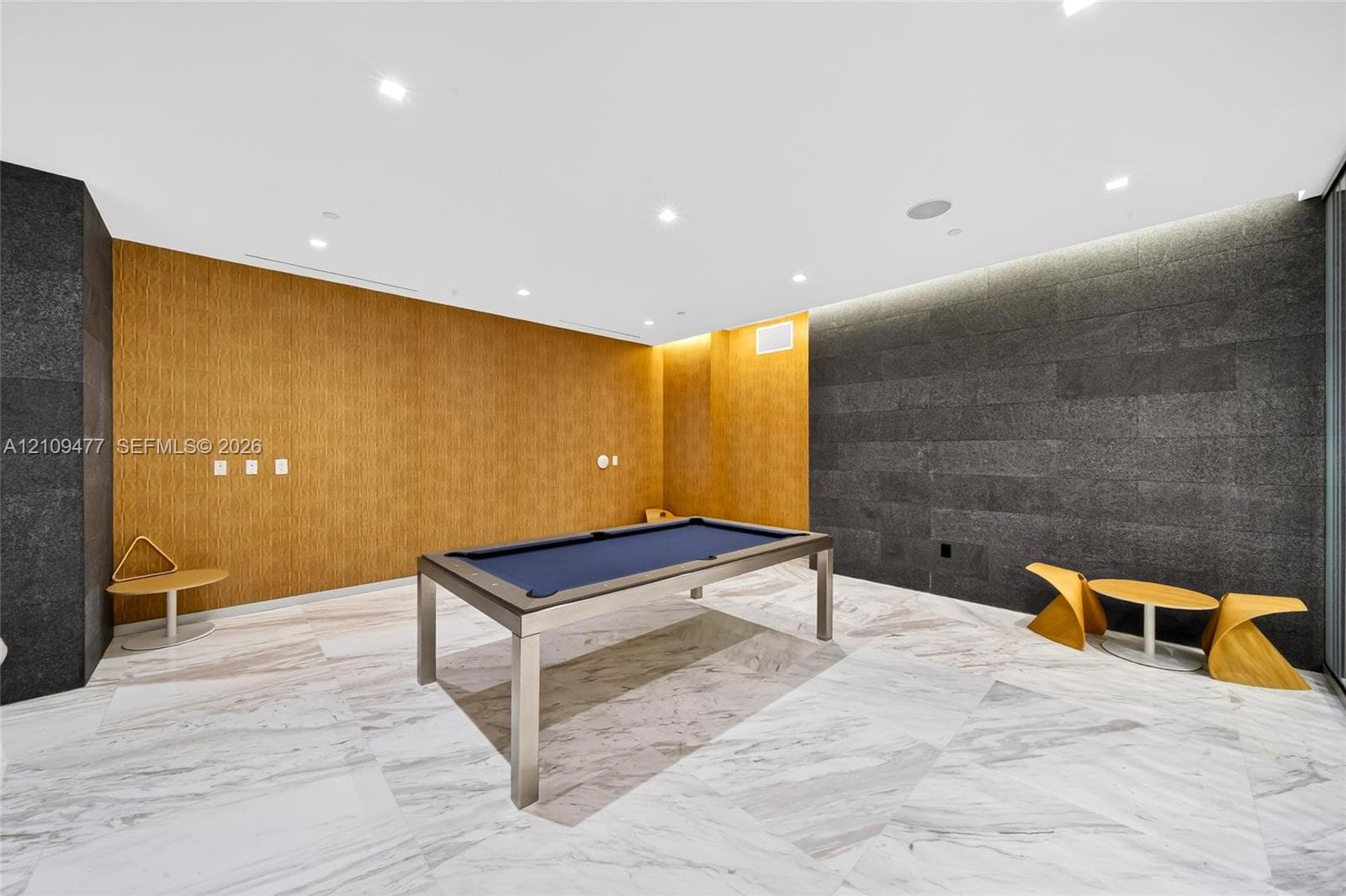 White louvered doors and a wall-mounted programmable thermostat