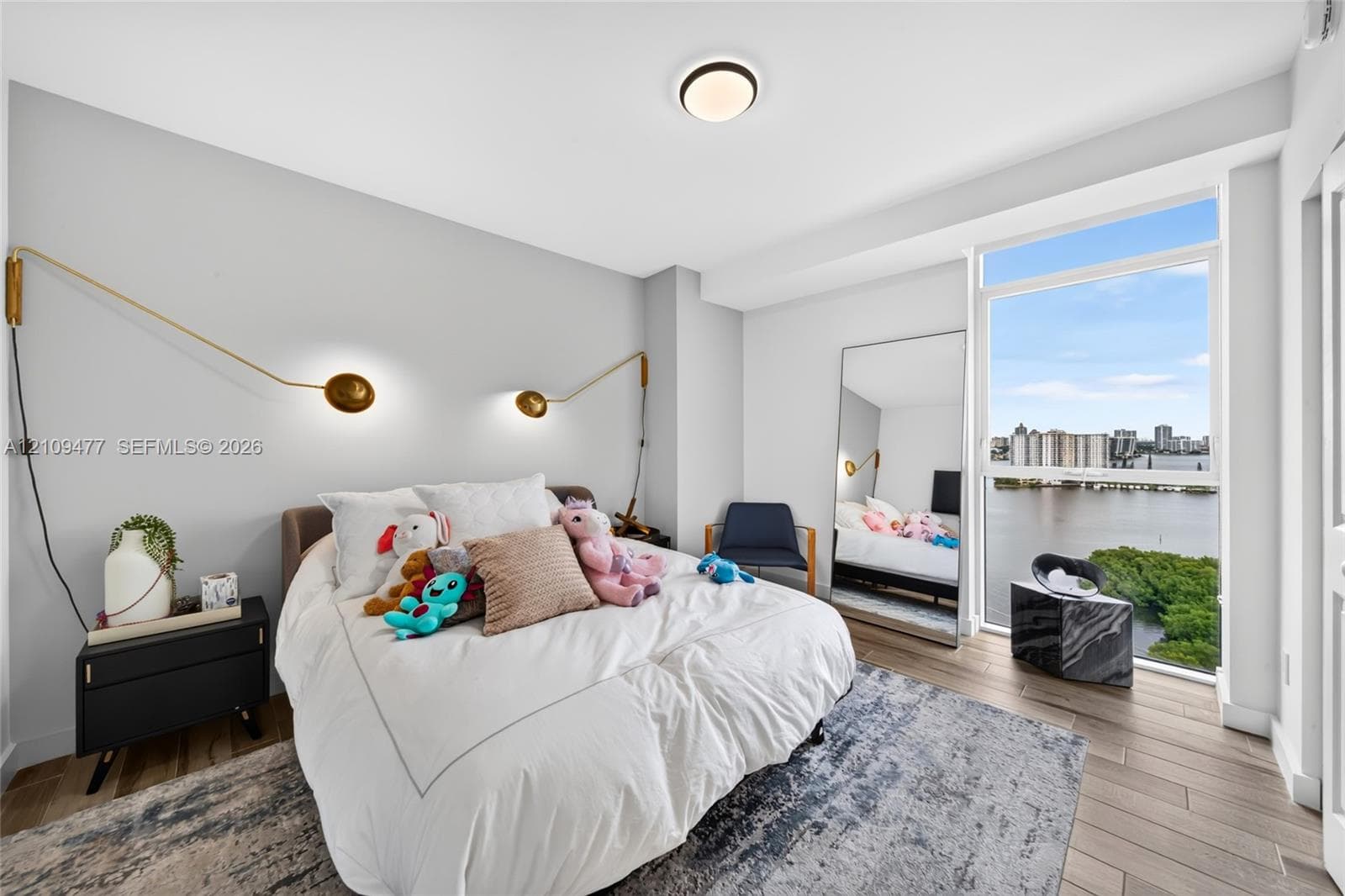Interior space featuring large-format stone floor tiles, natural wood-finish wall paneling, charcoal-toned stone feature walls, and recessed ceiling lighting
