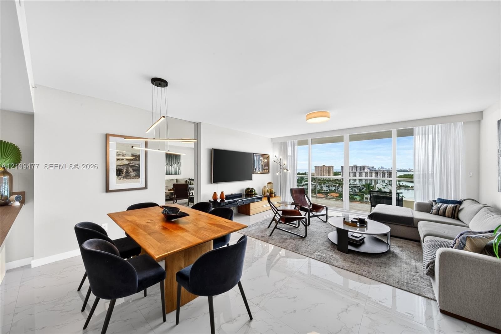 Interior space featuring wood-finish flooring, floor-to-ceiling windows, flush-mount ceiling lighting, and a double-door closet