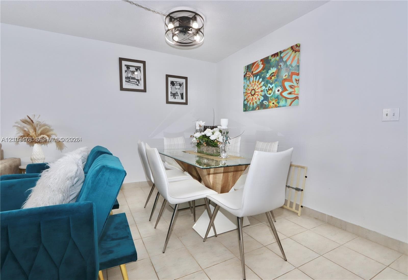 Neutral tile flooring and a modern drum-style flush mount ceiling light fixture