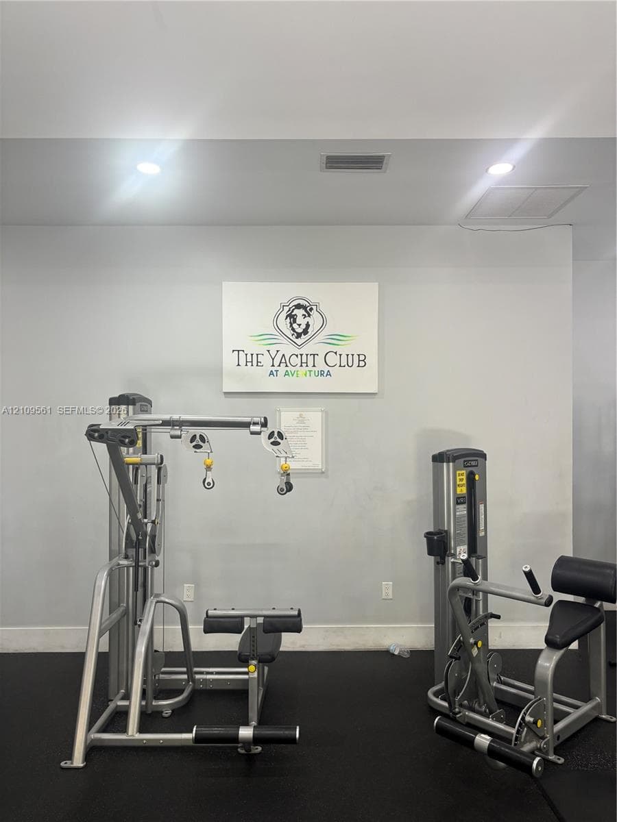 Fitness center featuring rubberized flooring and recessed ceiling lighting
