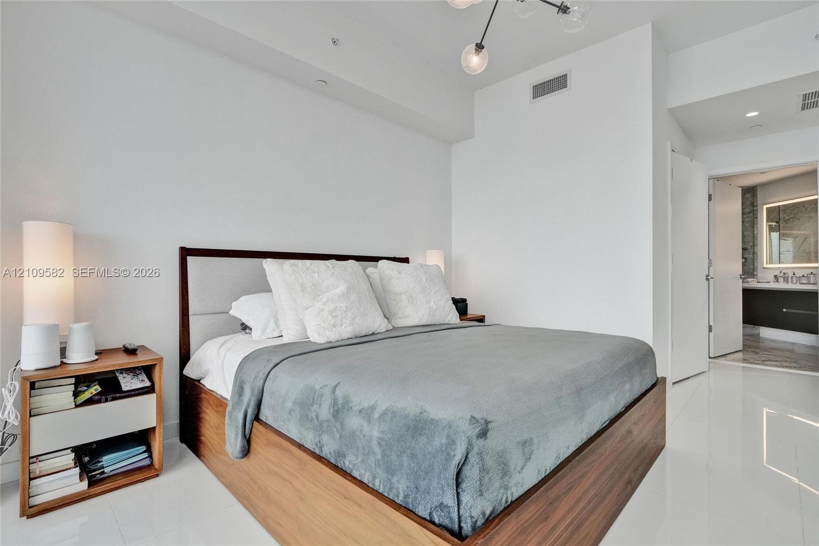 High-gloss tile flooring, contemporary multi-globe pendant light fixture, and neutral wall finishes