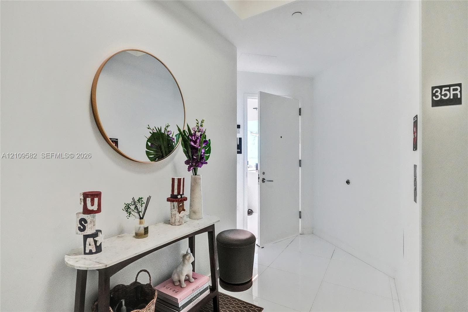 Entryway featuring white tile flooring, recessed ceiling lighting, and a neutral color palette