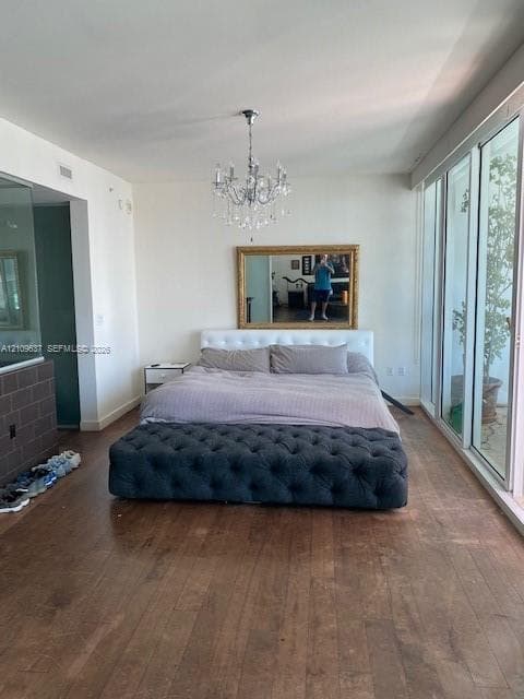 Wood-finish flooring, floor-to-ceiling glass wall with sliding doors, and a crystal chandelier