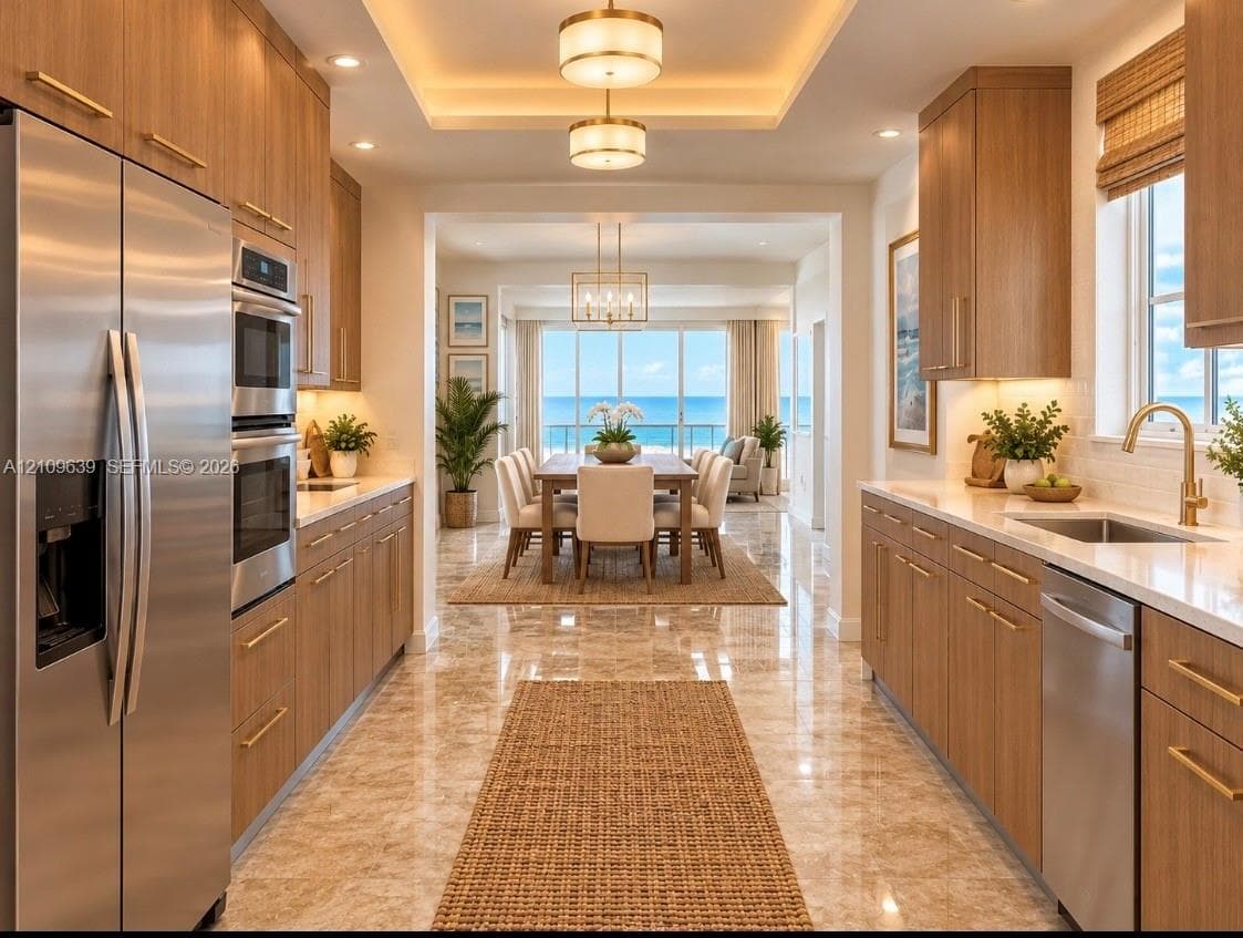 Galley kitchen featuring flat-panel wood cabinetry, stone countertops, stainless steel appliances, recessed ceiling lighting, and polished stone flooring