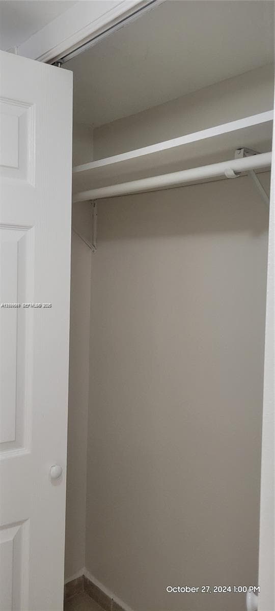 Closet featuring a bi-fold door, overhead shelf, and integrated hanging rod