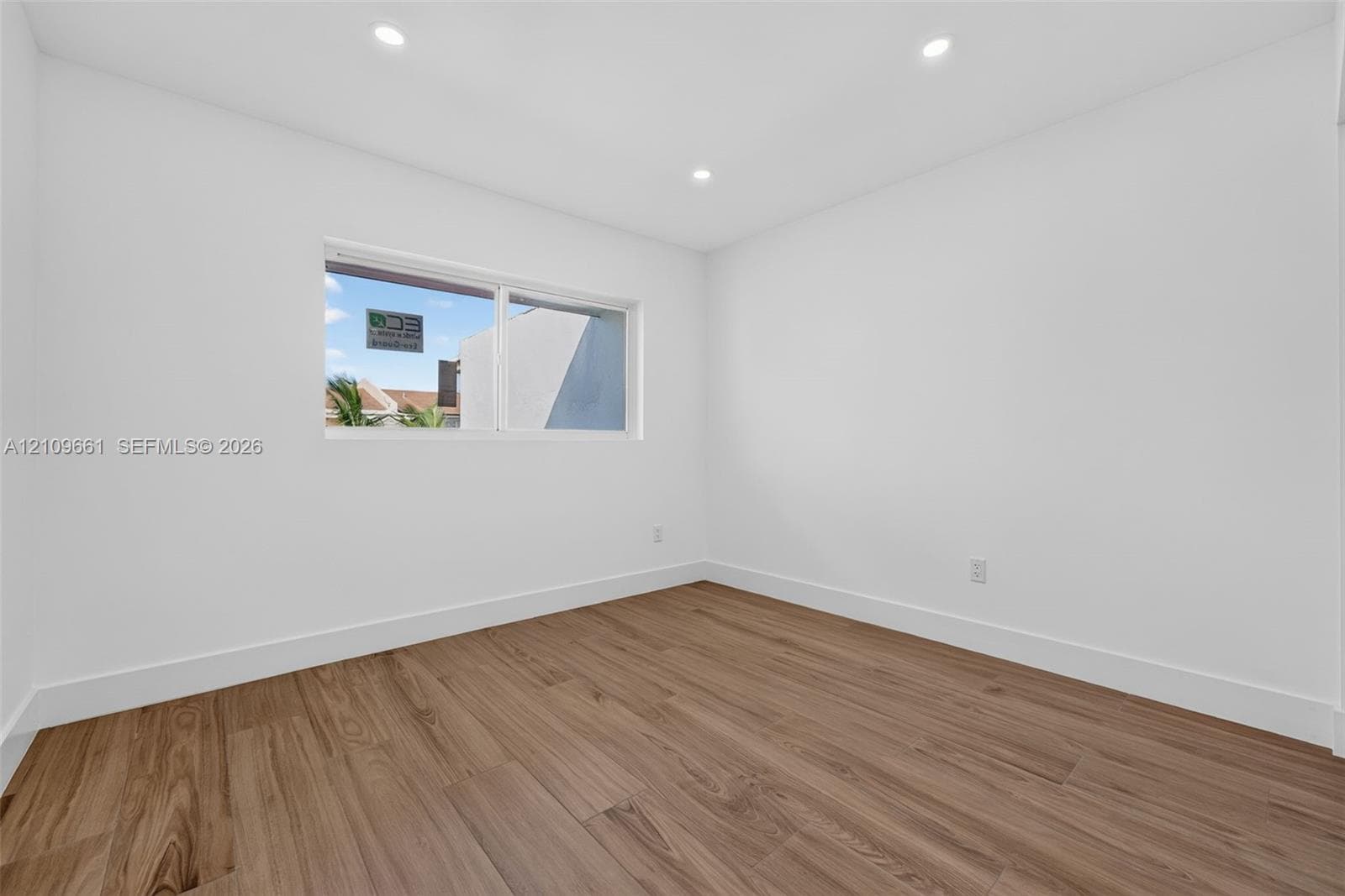 Interior space featuring wood-finish flooring, recessed lighting, and a large horizontal sliding window