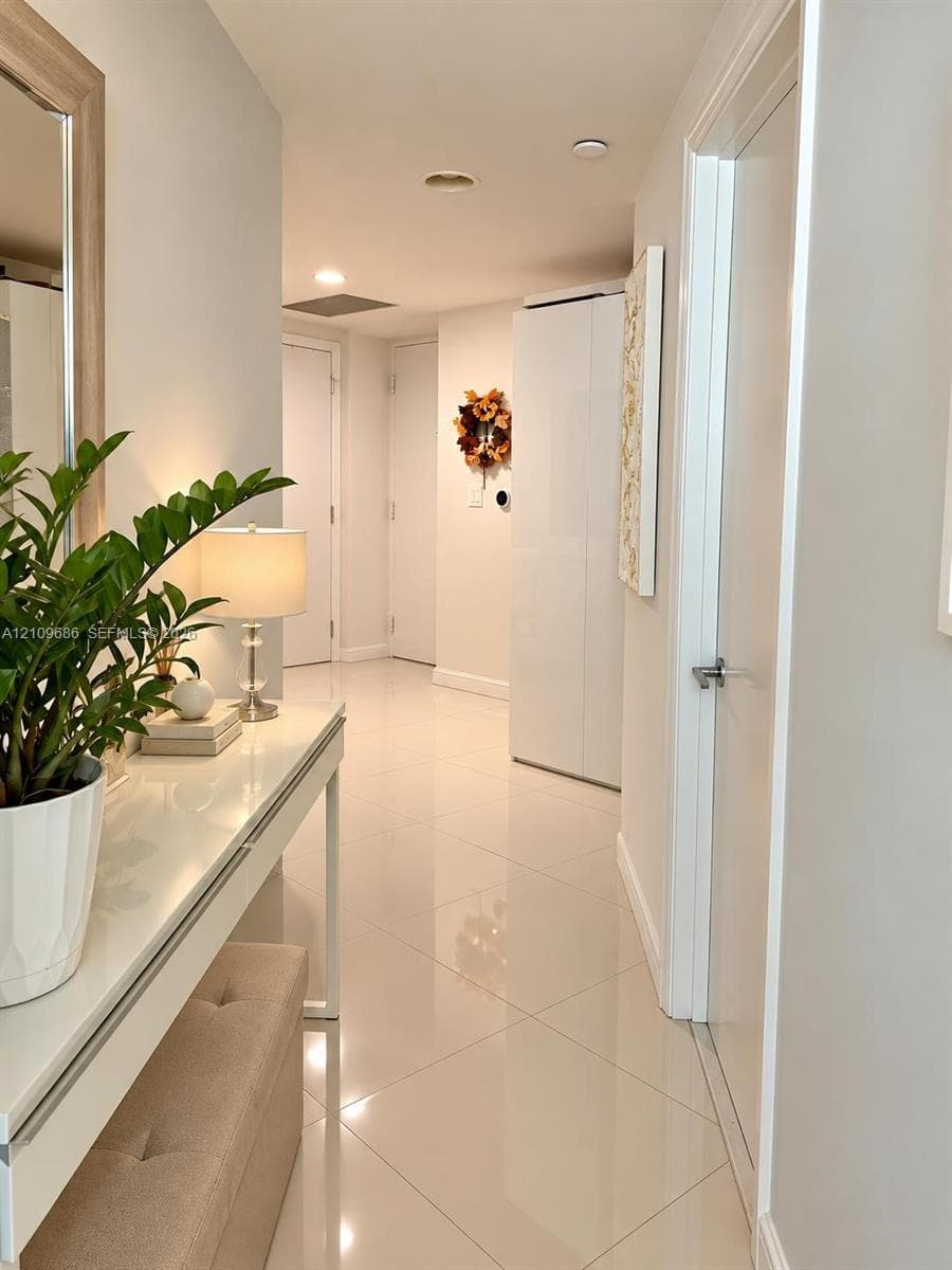 Polished tile flooring, neutral wall finishes, and multiple interior door access points