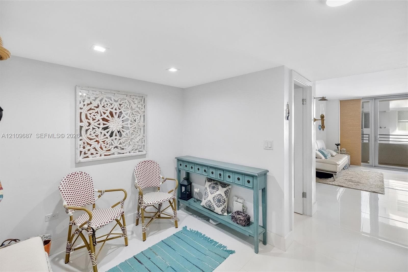 Polished tile flooring, recessed ceiling lighting, and glass-paneled patio doors