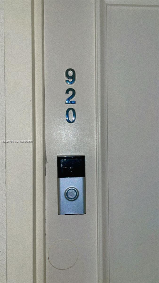 Flat-panel door featuring metallic numerical address digits and a mounted digital doorbell camera