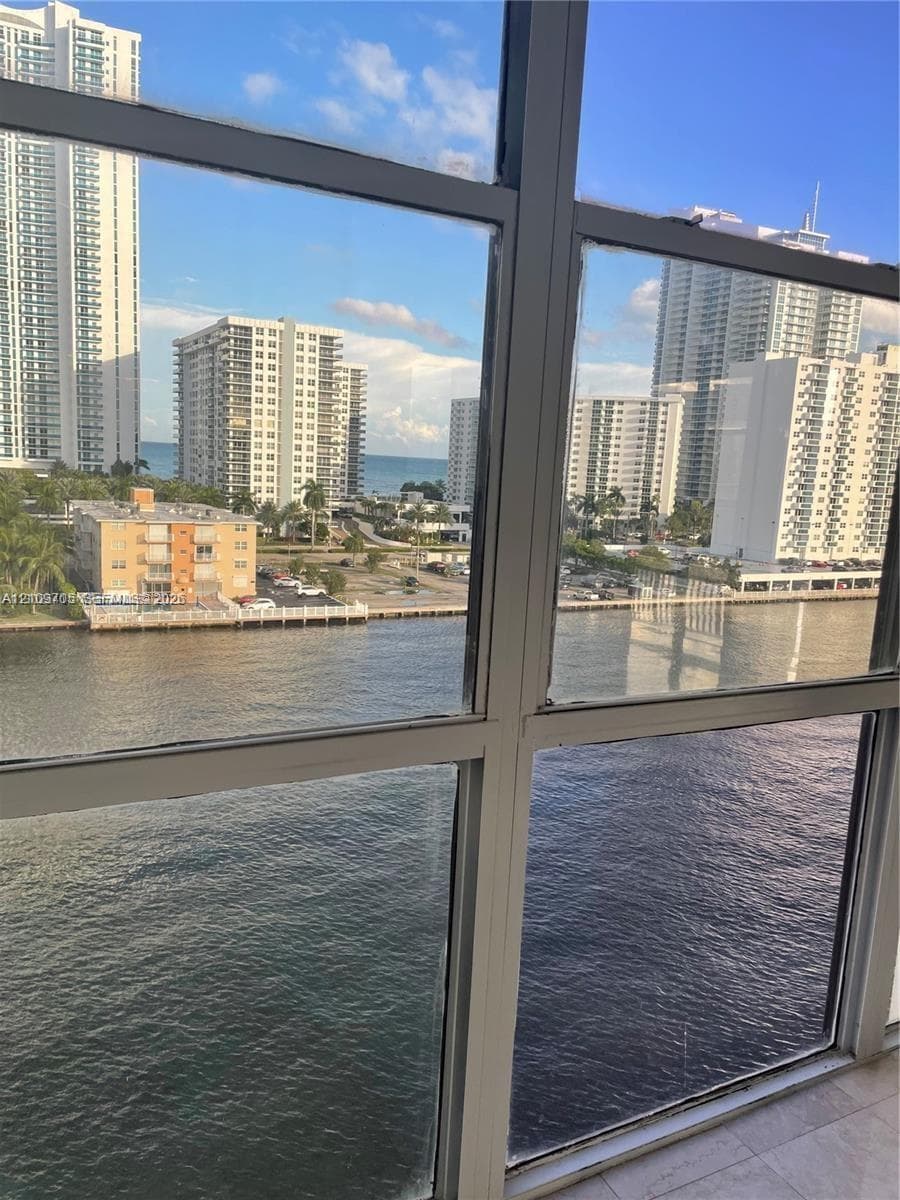 Floor-to-ceiling windows featuring aluminum frames and unobstructed water and cityscape surroundings